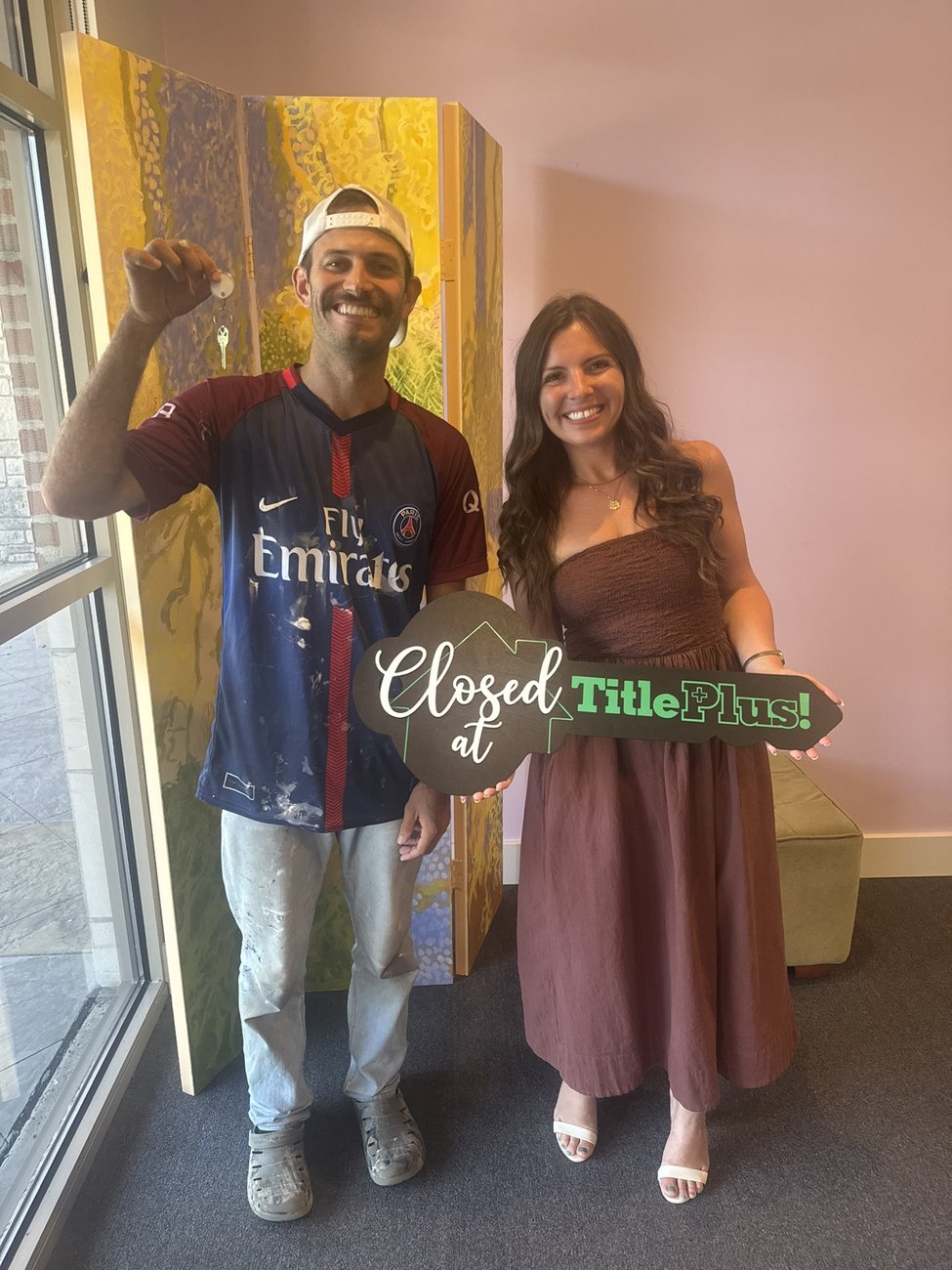 Lavinia Chudy celebrating a closing with a happy client at TitlePlus in Bloomington, IN