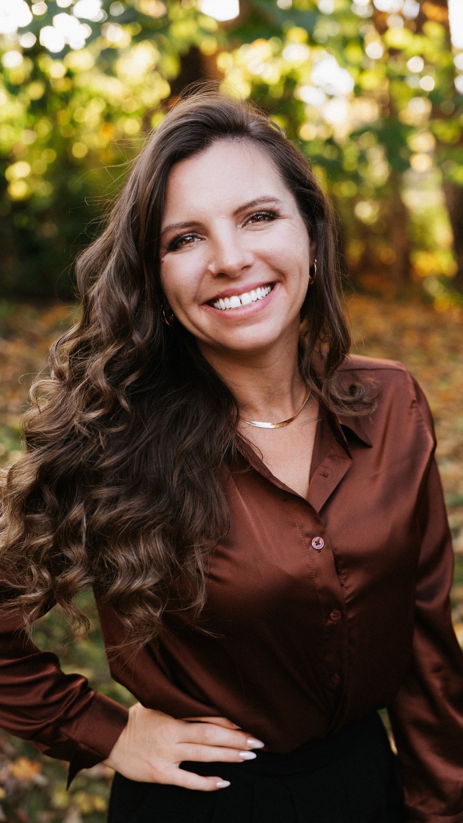 Lavinia Chudy, Bloomington Indiana realtor, professional headshot in a satin blouse